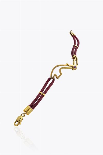 BRACCIALE : Peso lordo gr 8 6 firmato Quartaroli  con struttura in cuoio ed elementi centrali in oro giallo; un rubino taglio carr� ed un diamante taglio brillante  - Asta Asta 205 Gioielli - Associazione Nazionale - Case d'Asta italiane
