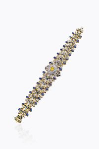 BRACCIALE - Peso gr 68 Lunghezza cm 18 in oro giallo e bianco  a cespuglio fiorito  con citrino centrale e zaffiri blu per  [..]