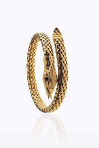 BRACCIALE - Peso gr 30 2 semirigido  in oro giallo  a forma di serpente. Occhi con gemme sintetiche rosse
