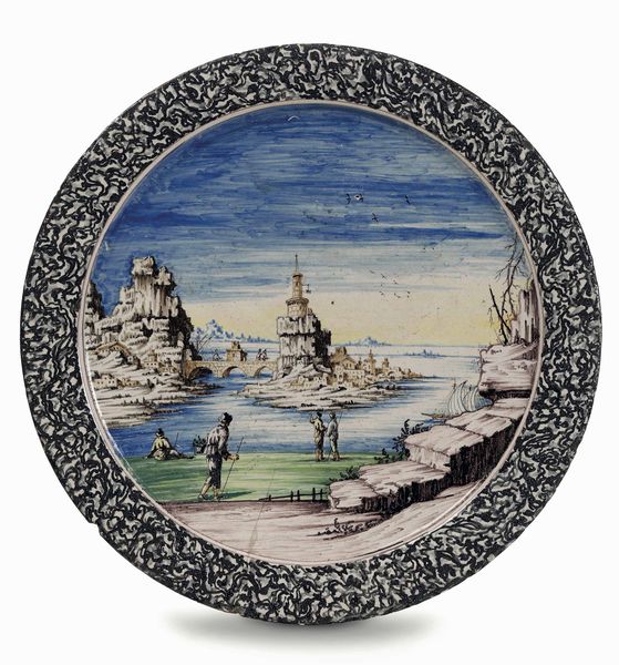 Raro ed eccezionale grande piatto a paese<BR>Pavia, Manifattura Imbres o Rampini, ultimo quarto del XVII - inizi del XVIII secolo<BR>Decorazione probabilmente di Siro Antonio Africa<BR>  - Asta Maioliche e Porcellane - Associazione Nazionale - Case d'Asta italiane