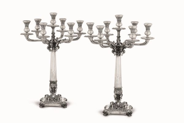Coppia di candelabri a sette fiamme. Argento fuso, sagomato e cesellato. Argenteria artistica siciliana del XX secolo. Argentiere Eugenio Stancampiano, Palermo  - Asta Argenti del XX secolo - Associazione Nazionale - Case d'Asta italiane