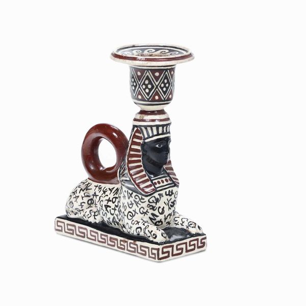 Candeliere a forma di sfinge.<BR>Napoli, Manifattura Giustiniani o Del Vecchio, primo terzo del XIX secolo  - Asta Dimore italiane  - Associazione Nazionale - Case d'Asta italiane