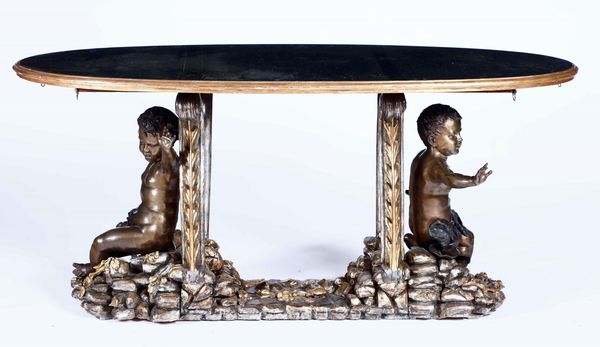 Tavolo in legno intagliato, dorato con putti in bronzo patinato. XX secolo  - Asta Dimore italiane  - Associazione Nazionale - Case d'Asta italiane
