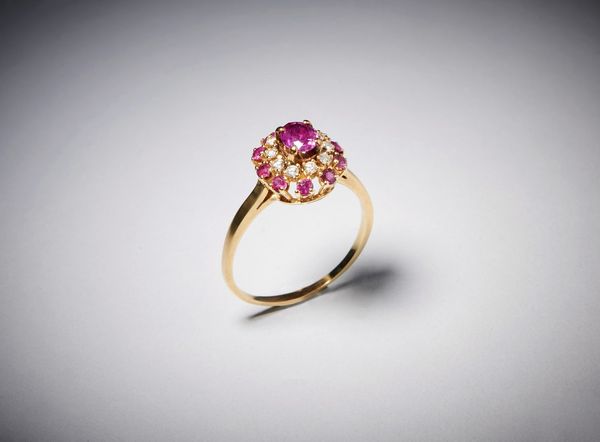 . : Anello tipo fascetta con rubino centrale ct: 0,70 contornato da diamanti taglio a brillante e rubini taglio brillante ct: 0,45 e 0,40.  - Asta Asta 366 | GIOIELLI - OROLOGI - Giunonicae Online - Associazione Nazionale - Case d'Asta italiane