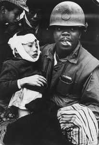 ,Philip Jones Griffiths - Marine with wounded child