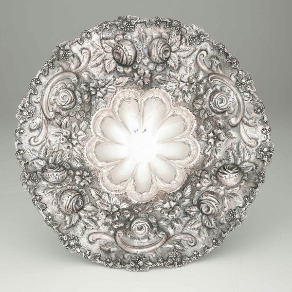 Centrotavola in argento fuso, sagomato e cesellato, con bordo mistillineo sbalzato a rose. Manifattura del XX secolo.  - Asta Argenti - Associazione Nazionale - Case d'Asta italiane