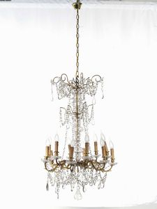 Coppia di lampadari a dodici luci in metallo dorato e pendenti in cristalli. XIX-XX secolo  - Asta Antiquariato Settembre - Associazione Nazionale - Case d'Asta italiane