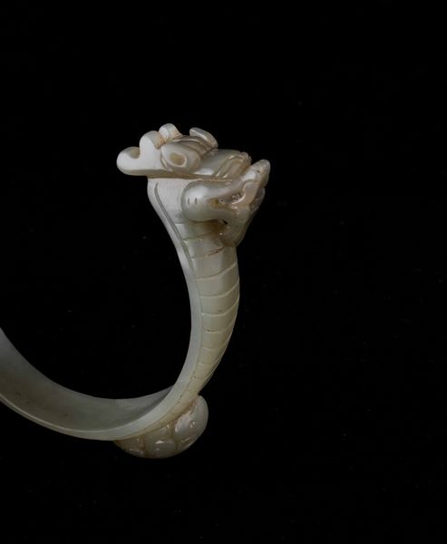 Bracciale scolpito in giada Celadon con figura di drago e animali a rilievo, Cina, Dinastia Qing, XIX secolo  - Asta Fine chinese works of art - Associazione Nazionale - Case d'Asta italiane