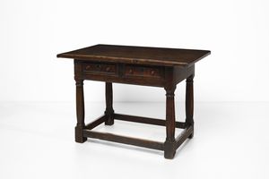 MANIFATTURA CENTROITALIANA DEL XVII SECOLO - Tavolino in noce a due cassetti sulla fascia, gambe a colonna unite da traverse