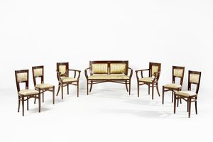 MANIFATTURA DEGLI INIZI DEL XX SECOLO - Salotto di gusto Deco composto da un divanetto, due poltrone e quattro sedie in legno intagliato con applicazioni in bronzo, schienali e sedute rivestiti di tessuto a decorazioni floreali