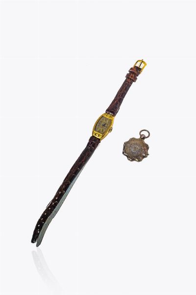 LOTTO DI DUE GIOIELLI : composto da: -orologio firmato Astrua  inizi XX secolo. Cassa di forma in oro giallo  incisa con motivi floreali. Quadrante (patina). Non funzionante -ciondolo portafoto in oro a bassa caratura  - Asta Gioielli - Associazione Nazionale - Case d'Asta italiane
