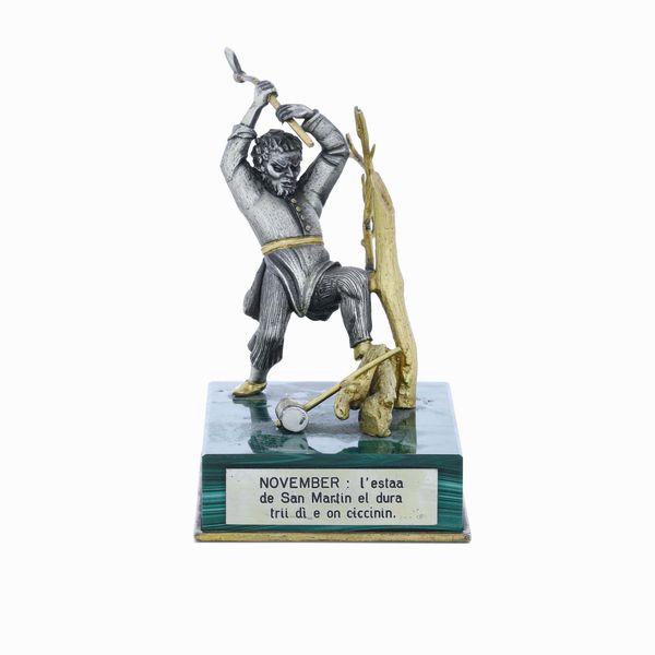 Taglialegna. Argento e argento dorato. Base in malachite. Argenteria artistica italiana del XX-XXI secolo  - Asta Argenti da collezione | XX secolo - Associazione Nazionale - Case d'Asta italiane