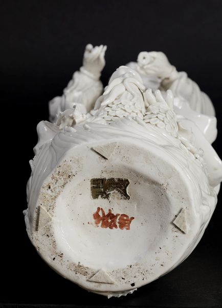 Figura in porcellana Blanc de Chine raffigurante Guanyin eretta su con vasetto, ramo fiorito e drago sulla base, Cina, inizi XX secolo  - Asta Arte Orientale - Associazione Nazionale - Case d'Asta italiane