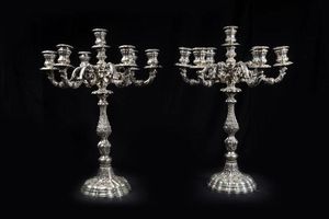 FASANO - Peso gr 6138 9 H cm 58 Coppia di candelieri a sette luci cadauno  firmati Fasano  interamente sbalzati e cesellati  [..]