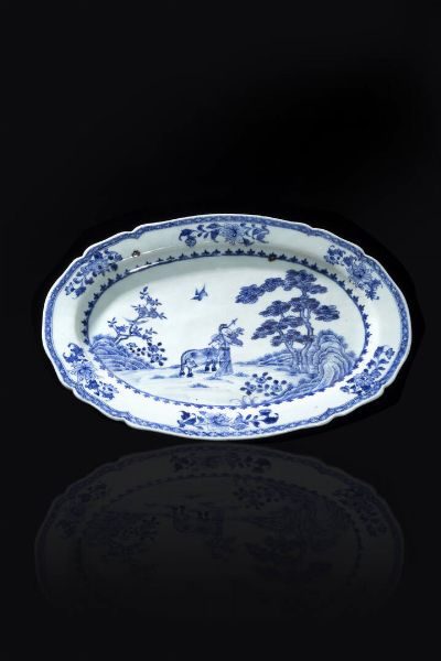 PIATTO : Piatto ovale in porcellana bianco e blu con figura di contadino entro paesaggio  Cina  dinastia Qing  epoca Qianlong (1736-1796) H cm 27x36  - Asta Arte Orientale - Associazione Nazionale - Case d'Asta italiane