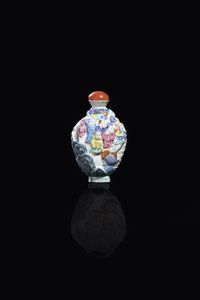 SNUFF BOTTLE - Snuff bottle in porcellana Famiglia Rosa decorata con personaggi a rilievo  Cina  dinastia Qing  XIX sec. H cm  [..]