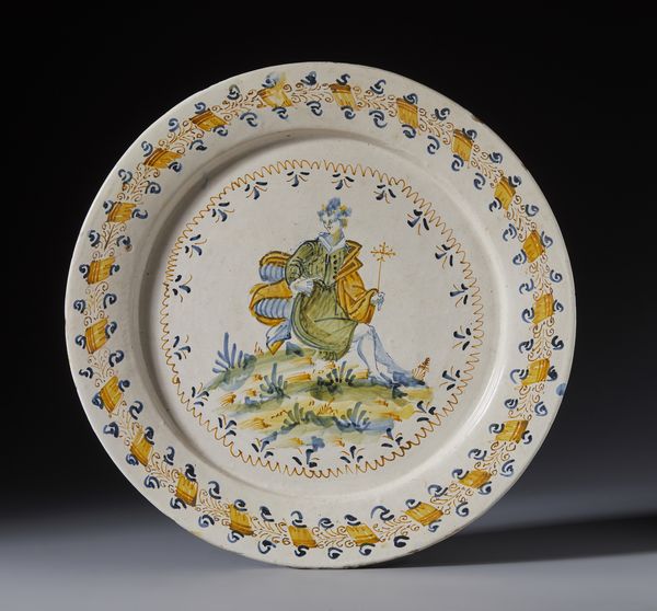 CASTELLI D'ABRUZZO, XVII SECOLO : Piatto in maiolica compendiaria a corpo circolare e tesa rilevata, decorato nel cavetto con figura allegorica entro doppia ghirlanda  - Asta Asta 395 | ARTE ANTICA E DEL XIX SECOLO Online - Associazione Nazionale - Case d'Asta italiane