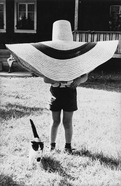 Frank Horvat : Morgarten, Switzerland, Lorenzo under hat, with cat  - Asta Fotografia: Under 1K - Associazione Nazionale - Case d'Asta italiane
