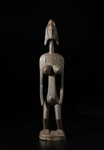 Bambara - Mali - Scultura antropomorfa femminile. Legno duro a patina scura.