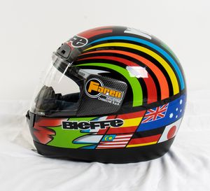 Motociclismo, Loris Capirossi , tuta da gara e casco autografati  - Asta Antique Toys & Sports Memorabilia - Associazione Nazionale - Case d'Asta italiane
