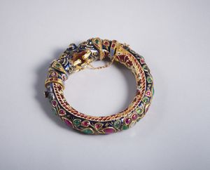 . - Raro e particolare  bracciale  indiano in lamina d'oro rappresentate due teste di elefante con smalti policromi, rubini, smeraldi e diamanti taglio a rosa. XIX secolo.