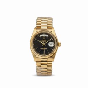 ROLEX - Daydate ref 18038 in oro giallo 18k, quadrante nero con indici applicati, indicazione di giorno e data, bracciale President con chiusura a scomparsa, movimento automatico