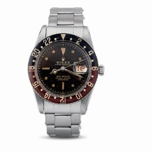 ROLEX - Estremamente raro e prezioso GMT Master ref 6542 Pepsi con ghiera in bachelite, quadrante virato tropical e datario roulette<BR>