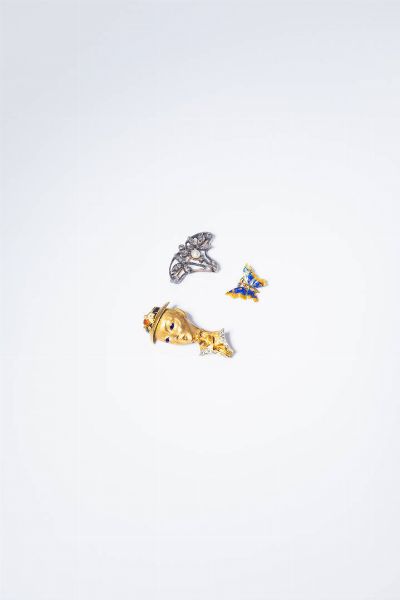 LOTTO DI TRE SPILLE : -in oro giallo  a forma di farfalla  con smalti policromi  Peso gr 1 9. Cm 1 5x1 5. -in oro giallo e bianco  satinato e lucido  a forma di testa di signora con cappello con smalti policromi. Peso gr 9 8. Cm 4x2. -in oro a bassa caratura ed argento  XIX secolo  a forma di voluta con rosette per totali ct 0 30 ca. Peso gr 5 1. Cm 2x3.  - Asta Gioielli - Associazione Nazionale - Case d'Asta italiane