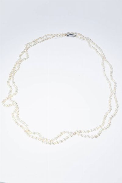 CIRIO E BONISOLI : Lunghezza cm 140 Lunga collana composta da perle di fiume  eseguita da Cirio -Bonisoli nel 1965. Chiusura in oro bianco e palladio con zaffiro taglio rettangolare di ct 0 61 e diamanti taglio 8/8 per totali ct 0 20 ca. Corredato di ricevuta della ditta Cirio-Bonisoli in data 1/10/1965.  - Asta Gioielli - Associazione Nazionale - Case d'Asta italiane