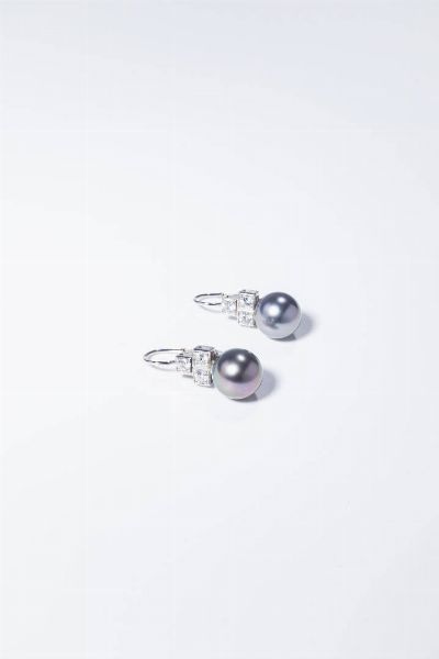 COPPIA DI ORECCHINI : Peso gr 7 4 in oro bianco  a monachella  con due perle Tahiti del diam. di mm 10 7 ca  sormontate da sei diamanti taglio brillante per totali ct 0 70 ca  probabile colore G-H  purezza IF-VVS.  - Asta Gioielli - Associazione Nazionale - Case d'Asta italiane
