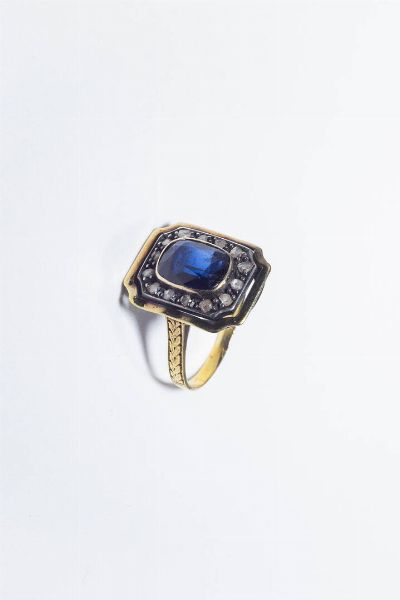 ANELLO : Peso gr 4 0 Misura 17 (57) in oro giallo a bassa caratura ed argento con zaffiro sintetico al centro e contorno di rosette per totali ct 0 30 ca.  - Asta Gioielli - Associazione Nazionale - Case d'Asta italiane