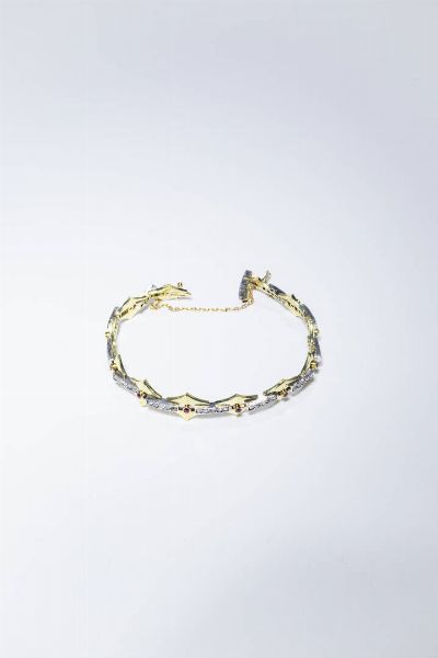 BRACCIALE : Peso gr 21 7 in oro giallo  composto da rombi con rosette per totali ct 0 50 ca e rubini sintetici.  - Asta Gioielli - Associazione Nazionale - Case d'Asta italiane