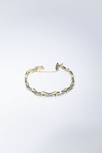 BRACCIALE - Peso gr 21 7 in oro giallo  composto da rombi con rosette per totali ct 0 50 ca e rubini sintetici.