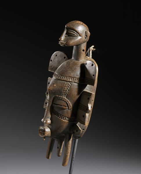 Senufo - Costa d'Avorio/Mali/Burkina Faso : Nello stile di Maschera antropozoomorfa in legno duro a patina marrone chiaro  - Asta Asta 444 | AFRICA, OCEANIA E AMERICHE - ARTIGIANATO AFRICANO: VARI COMMITTENTI E SELEZIONE DALLA COLLEZIONE BARTOLOMUCCI Online - Associazione Nazionale - Case d'Asta italiane