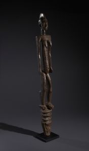 Mossi - Burkina Faso : Nello stile di Grande palo con scultura antropomorfa  in legno duro a patina bruno-rossastra  - Asta Asta 444 | AFRICA, OCEANIA E AMERICHE - ARTIGIANATO AFRICANO: VARI COMMITTENTI E SELEZIONE DALLA COLLEZIONE BARTOLOMUCCI Online - Associazione Nazionale - Case d'Asta italiane