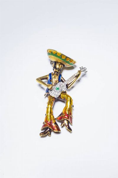 DAMIANI : Peso gr 55 7 Cm 9x4 Spilla in oro giallo e bianco  firmata Damiani  serie i Suonatori  a forma di suonatore di chitarra messicano  in smalto policromo e diamanti taglio 8/8 per totali ct 0 80 ca.  - Asta Gioielli - Associazione Nazionale - Case d'Asta italiane