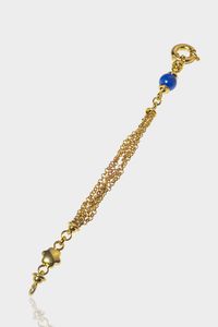 BRACCIALE - Peso gr 18.8 Lunghezza cm 19 in oro giallo con maglia ad anello; stellina a decoro e una sfera di lapislazzuli  [..]