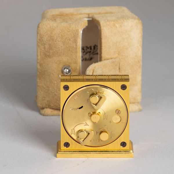 HERMES : Sveglietta da viaggio in ottone dorato a carica manuale con astuccio originale, 53x46 mm  - Asta Watches - Associazione Nazionale - Case d'Asta italiane