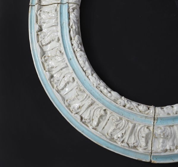 MANIFATTURA ITALIANA DEL XX SECOLO : Cornice di forma ovale in maiolica invetriata decorata a motivi fitomorfi a rilievo alternati a fasce di colore azzurro  - Asta Asta 469 | ARTE ANTICA E DEL XIX SECOLO Online - Associazione Nazionale - Case d'Asta italiane