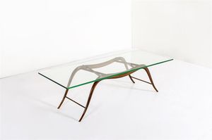BEGA MELCHIORRE - Tavolino con struttura in legno di noce  piano in vetro molato. Anni '40 cm 42x155x55 Bibl.: Irene de Guttry   [..]