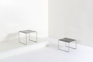 TAKAHAMA KAZUIDE - Due tavolini in metallo cromato  piano in vetro fum. Produzione Gavina Anni '70 rispettivamente cm 37x43x43 e  [..]