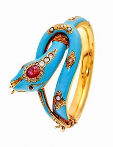 BRACCIALE - Peso gr 63 7 in oro giallo  a forma di serpente  decorato con smalto turchese; testa con rubini taglio ovale di  [..]