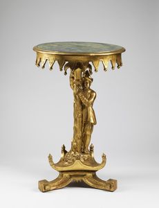MANIFATTURA ITALIANA DEL XIX SECOLO - Tavolino tondo in legno dorato, con base raffigurante un uomo in veste orientale poggiante su gamba tripode.