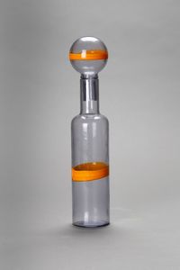 MANIFATTURA MURANESE - Bottiglia in vetro azzurrino  con applicazione di fascia in vetro giallo su tappo e corpo. Anni 70.