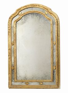 MANIFATTURA TOSCANA DEL XIX SECOLO - Specchiera in legno scolpito, dorato e intagliato, riccamente decorata a motivi fogliacei.