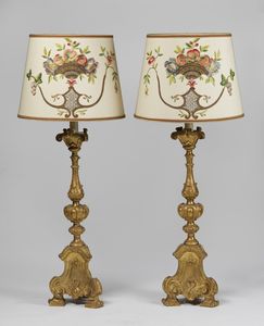 MANIFATTURA VENETA DEL XVIII SECOLO - Coppia di candeliere in legno intagliato e dorato montato a lampada, paralume in tessuto decorato a motivi floreali e vegetali.
