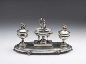 ARGENTIERE STEFANO FEDELI  (1794 - 1870) - Calamaio in argento sbalzato e cesellato decorato con figure classiche, base di forma ovale poggiante su figure di sfingi.