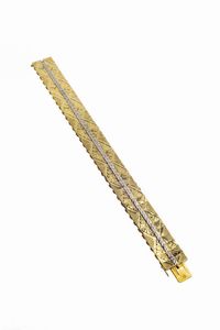 BRACCIALE - Peso gr 18 3 Lunghezza cm 18 in oro giallo e bianco  composto da segmenti rigidi incisi a motivi geometrici e  [..]