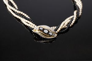 CARDIN PIERRE - Collier torchon con fili di perle artificiali colorate bianche e nere. Fibbia a forma di foglia stilizzata con strass bianchi e neri.