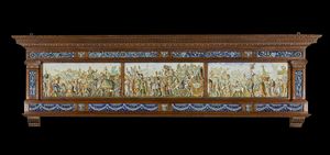 MANIFATTURA MOLARONI DEL XX SECOLO - Pannello in maiolica dipinta con i Trionfi di Cesare dal modello di Andrea Mantegna e cornice in legno scolpito.